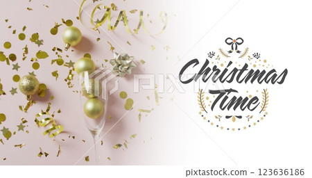 Image of christmas greetings text over christmas baubles in champagne glass 123636186