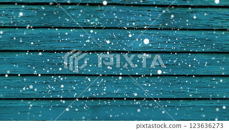 Image of snow falling over blue wooden surface Image of snow falling over blue wooden surface 123636273