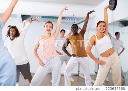 Group of different people rehearsing dance in dance studio 123636660