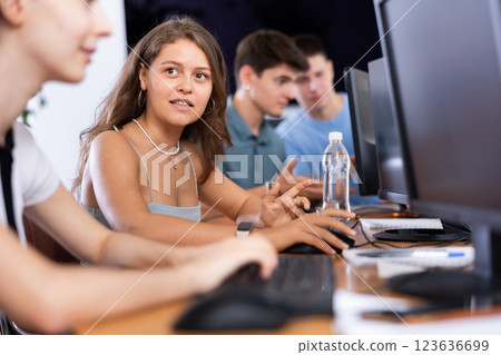 Motivated young female software developer working in IT startup Motivated young female software developer working in IT startup 123636699