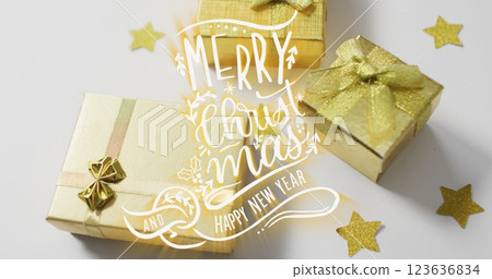 Image of merry christmas over presents on white surface Image of merry christmas over presents on white surface 123636834