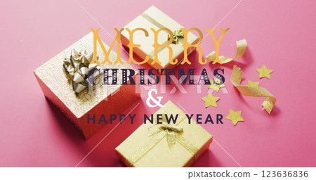 Image of merry christmas and happy new year over presents on pink surface Image of merry christmas and happy new year over presents on pink surface 123636836