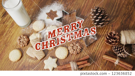 Image of merry christmas over cookies and decorations on wooden surface Image of merry christmas over cookies and decorations on wooden surface 123636852