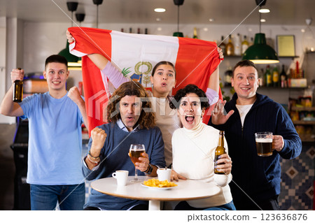 Enthusiastic Peruvian fans scream with joy in beer bar. Peruvian win Enthusiastic Peruvian fans scream with joy in beer bar. Peruvian win 123636876