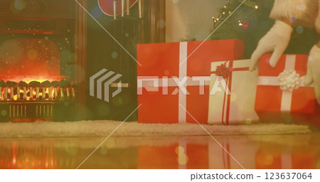 Image of white light spots over santa leaving christmas gifts under tree by fireplace Image of white light spots over santa leaving christmas gifts under tree by fireplace 123637064