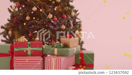 Image of yellow spots of light floating over a decorated christmas tree and gifts Image of yellow spots of light floating over a decorated christmas tree and gifts 123637092