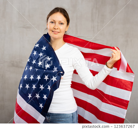 Adult woman covering herself with USA flag Adult woman covering herself with USA flag 123637267
