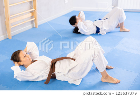 Two women training their abs in studio Two women training their abs in studio 123637379