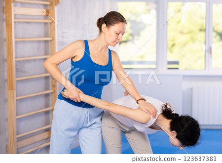 Two women learning strength self-defense in gym 123637381