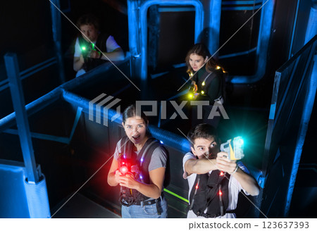 Team of young people play laser tag in labyrinth. View from above Team of young people play laser tag in labyrinth. View from above 123637393