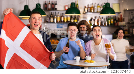 Joyful fans of the Denmark team celebrating the victory in night bar Joyful fans of the Denmark team celebrating the victory in night bar 123637443