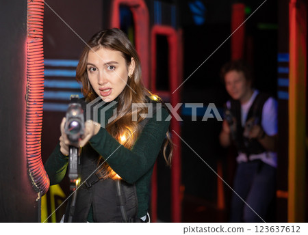 Young woman playing lasertag in arena 123637612