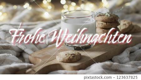 Frohe weihnachten text in white over christmas cookies and milk with bokeh lights 123637825