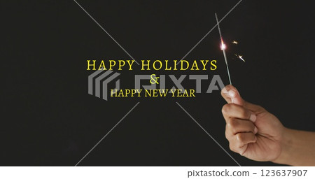 Image of happy new year text over man holding sparkler 123637907