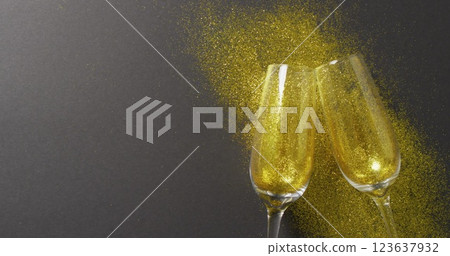 Image of happy new year text over champagne glasses 123637932