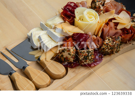 Cheese and meat charcuterie board. Gift present idea, dinner lunch plate. Minimal effort visually pleasing snacks. Simple meal preparation with special cheese knives 123639338