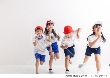 Elementary school student running in gym clothes Elementary school student running in gym clothes 123639434