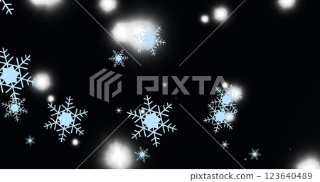 Image of snowflakes and white spots of light floating against black background with copy space 123640489