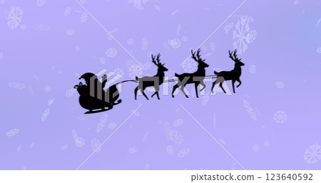 Santa claus in sleigh being pulled by reindeers over snowflakes falling against purple background 123640592