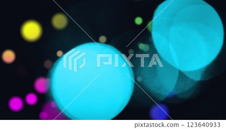 Image of snowflakes icons falling over colorful spots of light against black background Image of snowflakes icons falling over colorful spots of light against black background 123640933