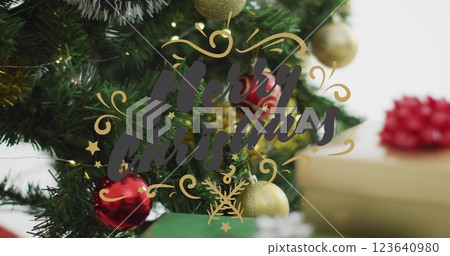Image of merry christmas text banner over close up of decorated christmas tree and gifts Image of merry christmas text banner over close up of decorated christmas tree and gifts 123640980