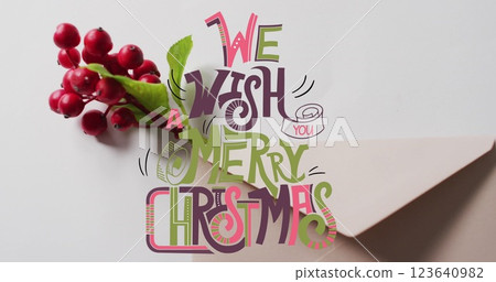 Image of merry christmas text banner over red berries and envelope on grey surface Image of merry christmas text banner over red berries and envelope on grey surface 123640982