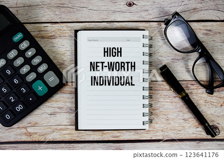 High Net-Worth Individual (HNWI) text on notepad, Business and Financial concept background 123641176