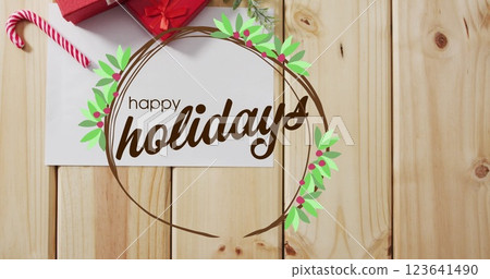 Image of happy holidsya text over christmas decorations and card with copy space 123641490