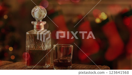 Image of wine decanter and glass, christmas stockings hanging Image of wine decanter and glass, christmas stockings hanging 123641568