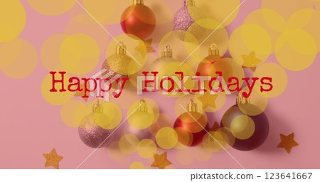 Image of happy holidays text over christmas baubles 123641667