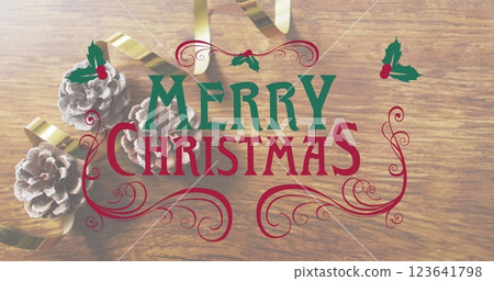 Image of merry christmas text banner against decorative flowers and ribbon on wooden surface Image of merry christmas text banner against decorative flowers and ribbon on wooden surface 123641798