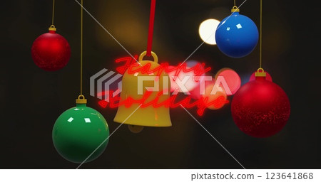 Image of happy holidays text with colorful baubles and bell hanging over lens flare 123641868