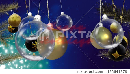 Image of happy holidays text with baubles, stars, feathers hanging on blue background Image of happy holidays text with baubles, stars, feathers hanging on blue background 123641878