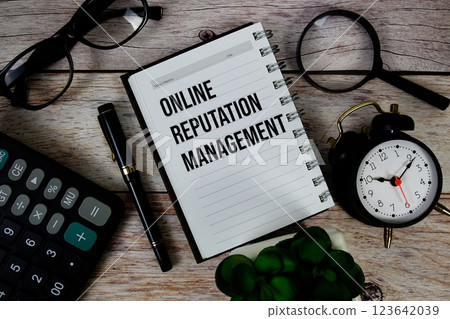 Online Reputation Management (ORM) text on notepad, Business and Financial concept background 123642039