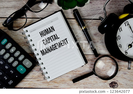 Human Capital Management (HCM) text on notepad, Business and Financial concept background 123642077
