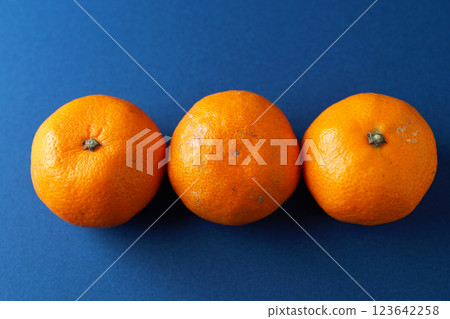 Mandarins placed on a blue background Mandarins placed on a blue background 123642258