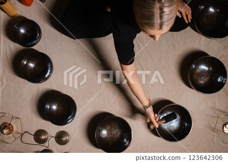 Sound therapy session with Tibetan singing bowls in a calming indoor setting during the afternoon 123642306