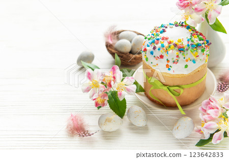 Celebrating easter with a beautifully decorated cake, colorful eggs, and fresh flowers Celebrating easter with a beautifully decorated cake, colorful eggs, and fresh flowers 123642833
