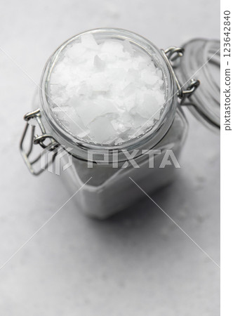 Magnesium flakes stored in a glass jar with metal clasp lid 123642840