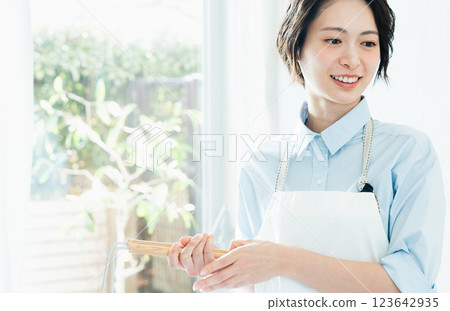 A woman holding a laundry basket A woman holding a laundry basket 123642935