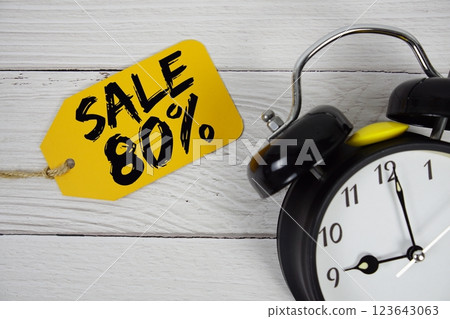 Sale 80% on price tag with alarm clock on wooden background 123643063