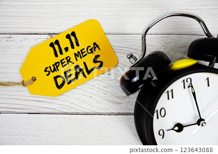 11.11 Super Mega Deals Promotion on price tag with alarm clock on wooden background 11.11 Super Mega Deals Promotion on price tag with alarm clock on wooden background 123643088