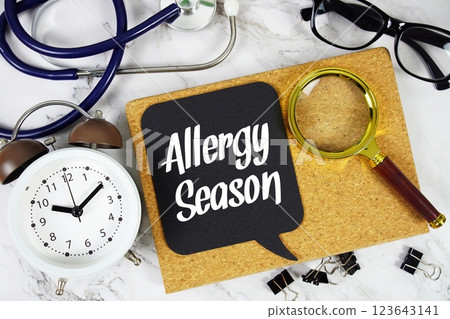 Allergy Season text on speech bubble with alarm clock, magnifying glass and stethoscope on marble background Allergy Season text on speech bubble with alarm clock, magnifying glass and stethoscope on marble background 123643141