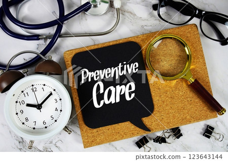 Preventive Care text on speech bubble with alarm clock, magnifying glass and stethoscope on marble background 123643144