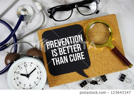 Prevention Is Better Than Cure text on speech bubble with alarm clock, magnifying glass and stethoscope on marble background Prevention Is Better Than Cure text on speech bubble with alarm clock, magnifying glass and stethoscope on marble background 123643147