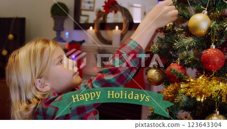 Image of season's greetings text over caucasian boy and christmas tree 123643304