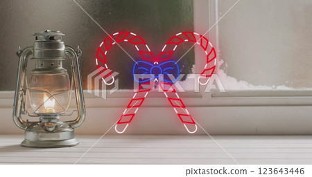 Image of neon candy canes over christmas lantern decoration 123643446