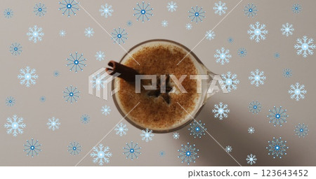 Image of snow falling over christmas drink and decorations 123643452