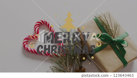 Image of christmas greetings text over christmas present and decorations Image of christmas greetings text over christmas present and decorations 123643463