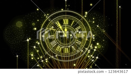 Image of clock showing midnight and fireworks exploding on black background 123643617